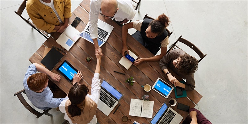 People working together round a table at a meeting
