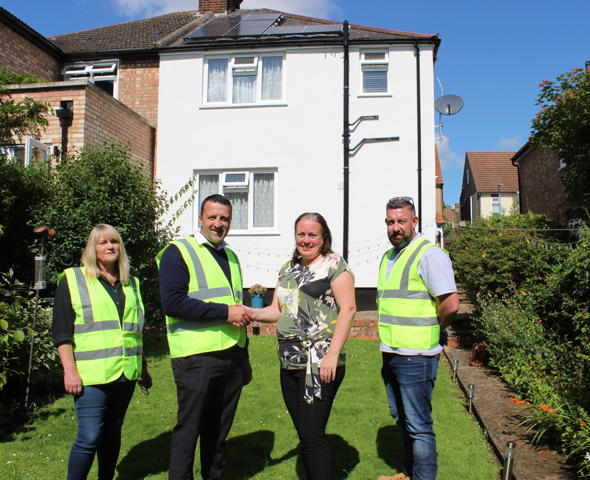 Cllr Jacqui Taylor, 3rd from left, shakes hands on the £18 million deal with CCS’s Danny Gladwyn, 2nd from left, at the Breakspear Avenue property with, far left,  Tina Harvey, CCS’s Senior Resident Liaison Officer, and, far right, James Kendrick, CCS’s Retrofit Site Supervisor. 