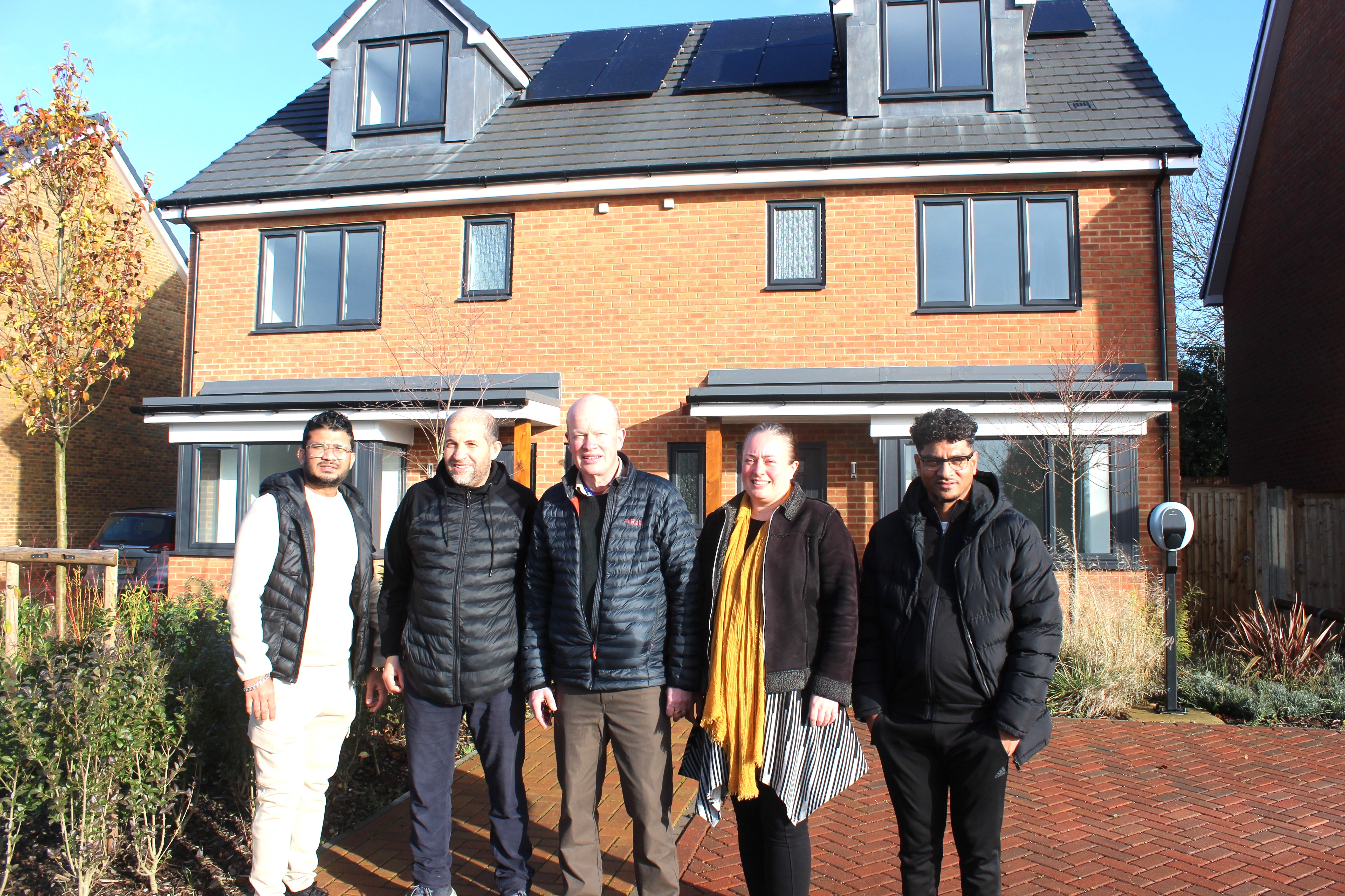 Cllr Jacqui Taylor (4th from left) and Cllr Paul De Kort (3rd from left) at the Viking Close development with some of the new tenants