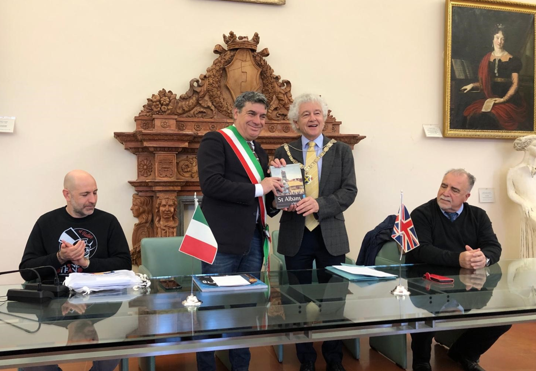 Cllr Rowlands, Mayor of St Albans City and District, 2nd right, presents his gift to Fano Mayor, Massimo Seri