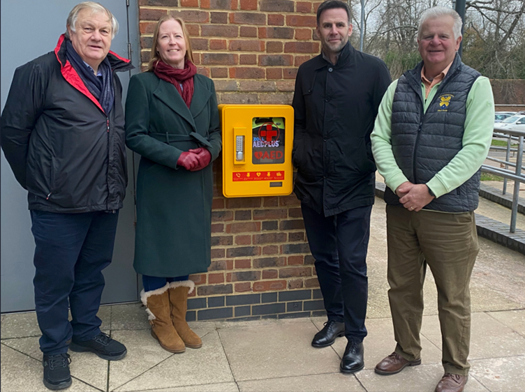 from the left; examining the new defibrillator are John Turkentine, Vice-President and Coach of Batchwood Hall Golf Club; Councillor Helen Campbell, Lead for Leisure; James McNulty, Everyone Active’s Contract Manager; and Richard Sullivan, Club Captain of Batchwood Hall Golf Club.