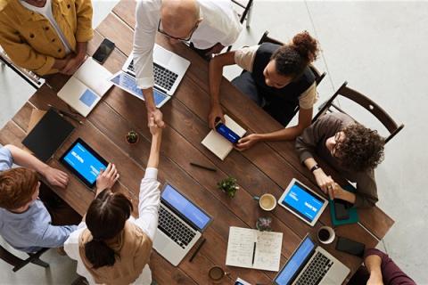 People working together round a table at a meeting