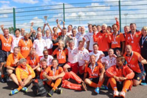 Cllr Salih Gaygusuz, St Albans Mayor (centre), with the England 055’s team who are the O55's European Champions 2015, with their Dutch opponents who they beat in the final. On the Mayor’s right, holding the trophy cup aloft, is the England captain, Mark Precious.