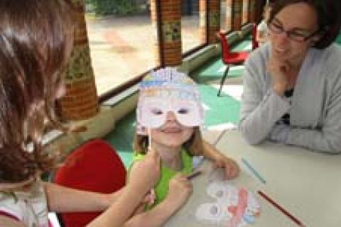 Child wearing the Roman face masks they were making at Verulamium Museum