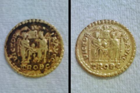 One of the gold coins, both before and after it was cleaned to go on display. The coin is a solidus, showing Honorius and his brother Arcadius, Emperors of the Eastern and Western Roman Empires, wearing their robes of office and seated side by side