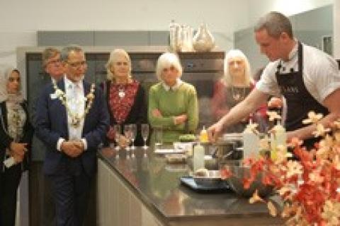 Chef in kitchen with Mayor