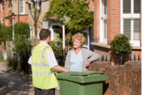 waste collector talks with lady on street