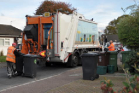 Waste truck and bins on street